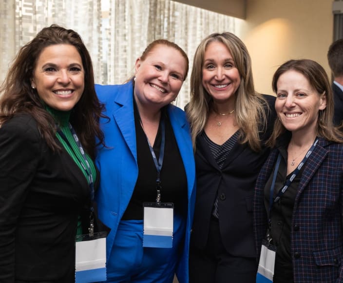 A group of 4 female team members of GRSM posing in the office.